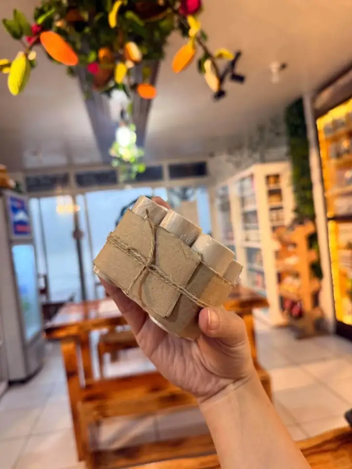 Hand holding fresh tablea at the shop
